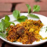 Lamb Biryani · Basmati rice with lamb in a masterful blend of spices. Garnished with nuts and raisins.