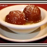 Gulab Jamun · A sweet pastry ball served in a honey flavored syrup.