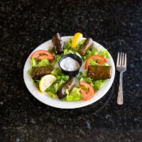 Grape Leaves · A mixture of rice, onions, tomatoes, and parsley wrapped in pickled grape leaves. Served wit...
