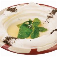 Labne Dip · A creamy smooth and tangy stained cheese topped with olive oil and mint. Served with warm pi...