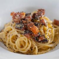 Spaghetti alla Carbonara · Spaghetti pasta with egg yoke, Pecorino Romano cheese, smoked guanciale and fresh crushed bl...
