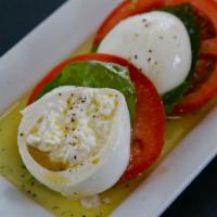 Caprese Salad · Roma tomato, burrata, basil, extra virgin olive oil
