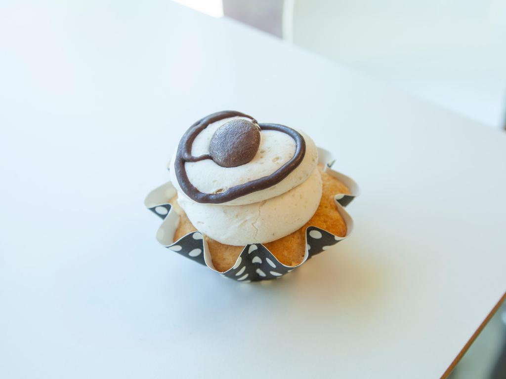 Cookie Dough Cupcake · Vanilla chocolate chip cake with chocolate chip cookie dough buttercream topped with chocolate ganache drizzle and mini chocolate chips.