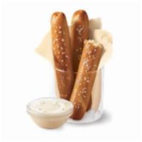 DQ Bakes!  Pretzel Sticks with Zesty Queso · Soft pretzel sticks, served hot from the oven, topped with salt and served with warm zesty q...