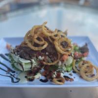 Steak Salad · Iceberg wedge, steak, blue cheese crumbles, bacon, tomato, crispy onions topped with blue ch...