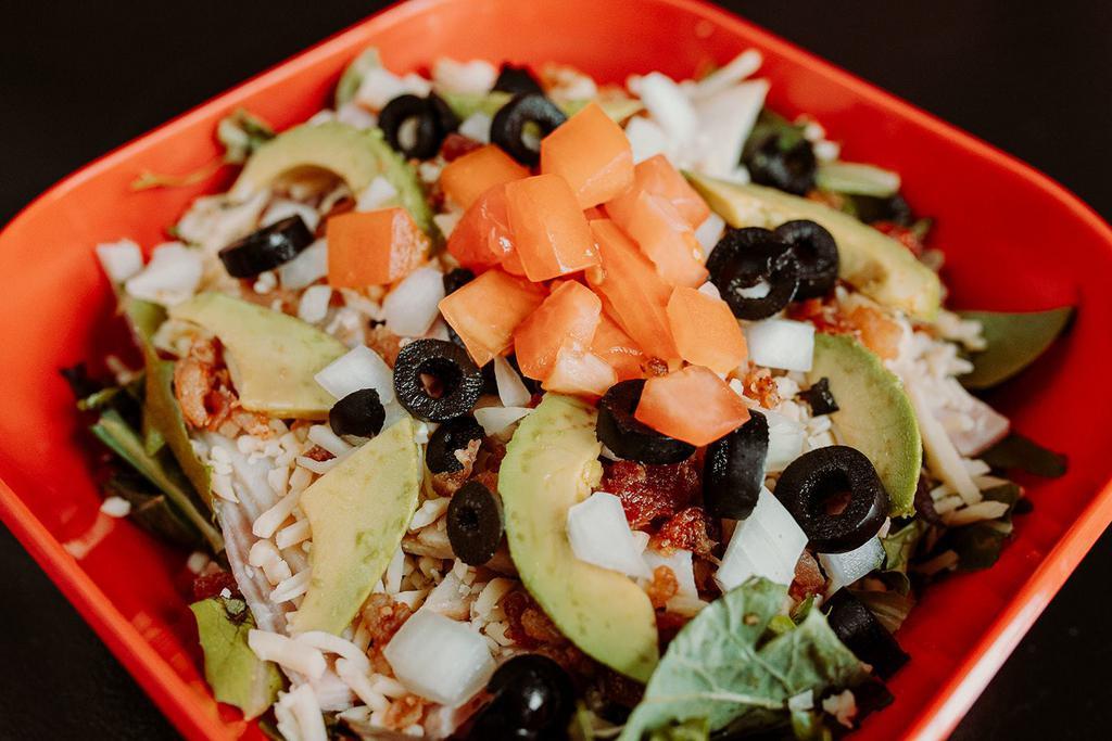 Cobb Salad · Turkey, ham, bacon bits, pepper jack, avocado, tomatoes, black olives and onion. Your choice of dressing