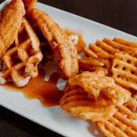 Chicken and Waffles · Three hand breaded chicken strips over one large waffle. Topped with our own honey sriracha ...