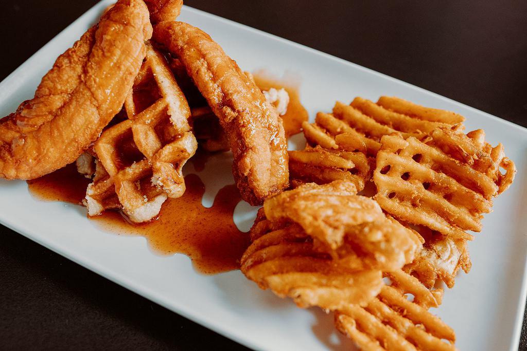 Chicken and Waffles · Three hand breaded chicken strips over one large waffle. Topped with our own honey sriracha sauce. Served with side of waffle fries.