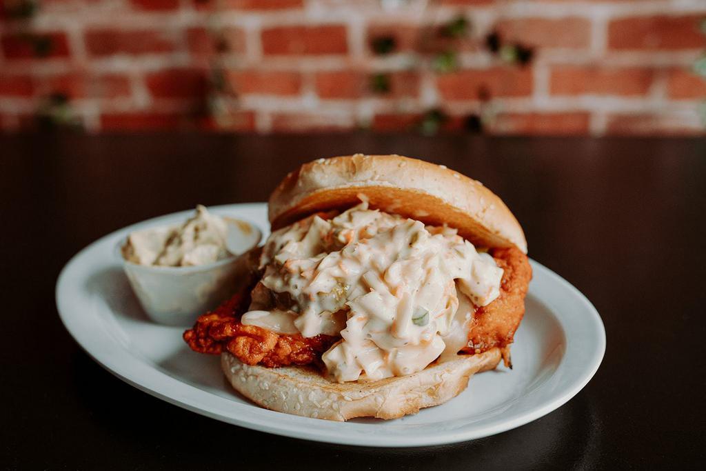 Nashville Hot Chicken Sandwich · Choice of grilled or crispy, served on a toasted bun with pepper jack cheese, pickles and homemade coleslaw. 