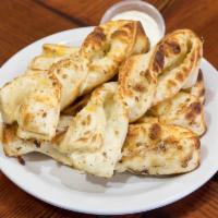 Garlic Parmesan Twists · Served with fresh garlic, 3 cheese blend and Parmesan cheese.