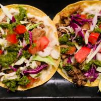 Chicken Taco · Perfectly marinated chicken shawarma with a garlic cream sauce, crispy cabbage with diced to...