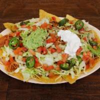 Nachos Supreme with Meat · Topped with shredded cheese,lettuce,tomatoes, jalapeño, sour cream, and guacamole.