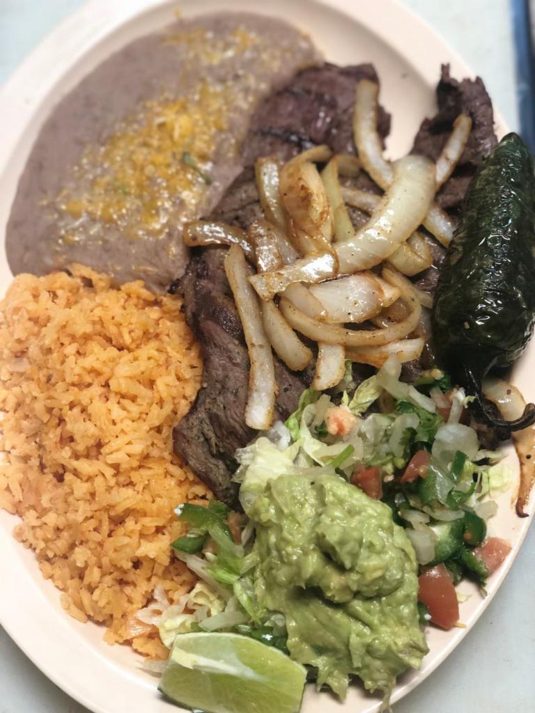 Carne Asada Plate · Includes beans, rice, guacamole, pico de gallo, and tortillas.