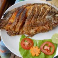 Fried Tilapia combo · Deep fried serve with steamed rice and a side of slice tomato and onion