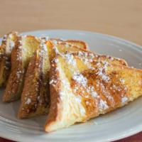 Classic French Toast · Thick slices of Texas toast battered in our signature dip, served with butter and syrup.