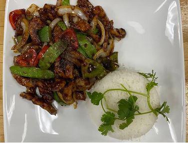 Spicy Chicken Stir Fry - Gà Xào Cay · A mixture of marinated chicken breast, broccoli, green and red bell peppers, onions combine with dark soy sauce and oyster sauce. Served with white steamed rice.