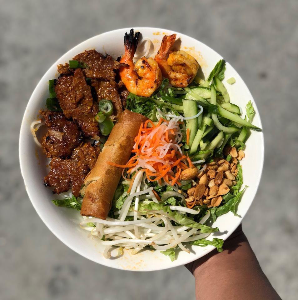 Grilled Beef, Shrimp and Egg Rolls - Bún Thịt Nướng (Bò) ·  A mixture of shredded lettuce, cucumbers, bean sprouts, carrots, basil and cilantro, topped with rice vermicelli, peanuts, fried shallots, grilled shrimp, and grilled beef. Served with fish sauce.