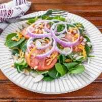 Spinach Salad · Fresh Baby spinach topped with fresh red onions vine ripe tomatoes shredded mozzarella and c...