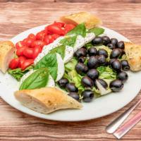 Caprese Salad · Lettuce, black olives, fresh mozzarella, basil, and balsamic.
