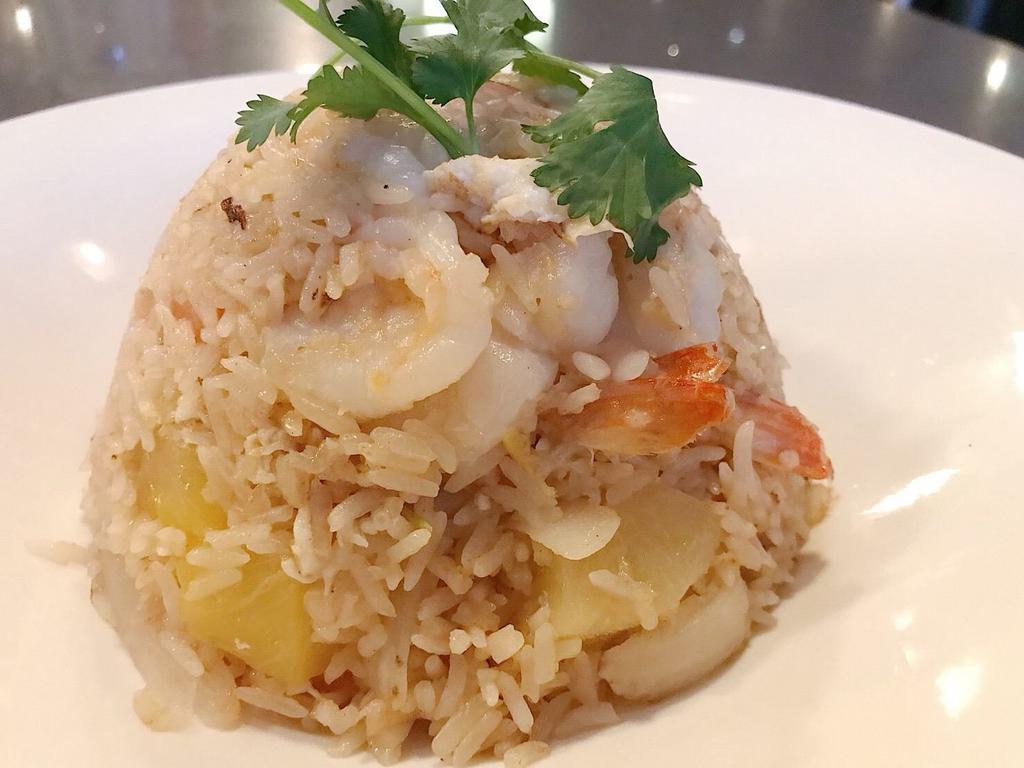 Pineapple Fried Rice · With egg, pineapple, onion, cashew nut, tomato, and scallions.