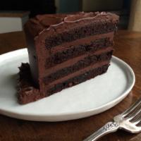 Special Triple Chocolate Cake Slice with Whip Cream · Chocolate cake filled with chocolate cream, layers of delicious chocolate fudge and finished...