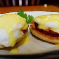 Eggs Benedict · Poached eggs on an English muffin with Hollandaise sauce and Canadian bacon. Served with pot...