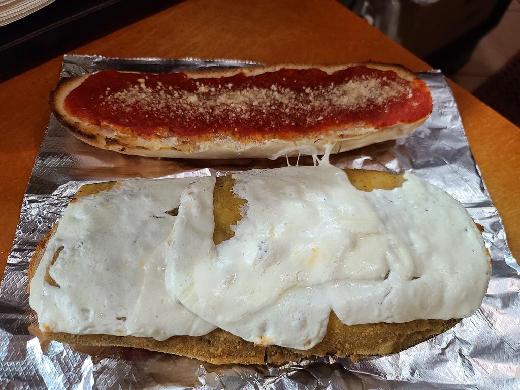 Eggplant Parmigiana Hero · Eggplant covered in Mozzarella cheese and our marinara sauce on a freshly baked Italian roll.