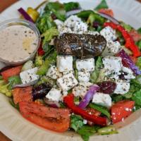 6. Greek Village Salad · Tomatoes, onion, cucumber, Kalamata olives, feta cheese, peppers, grape leaves, oregano, red...