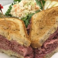 Rueben Sandwich · Choice of corned beef or pastrami with sauerkraut and melted Swiss cheese on grilled rye bre...