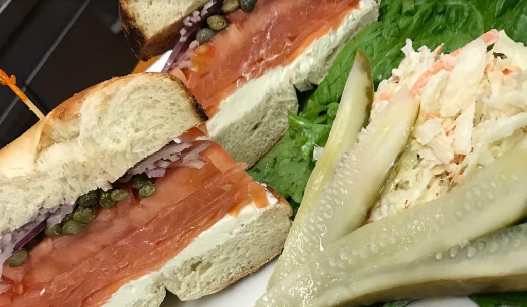Smoked Salmon and Cream Cheese Bagel · Served on a toasted NY bagel with capers, shaved onions, leaf lettuce and fresh tomatoes. Served with coleslaw and a pickle.