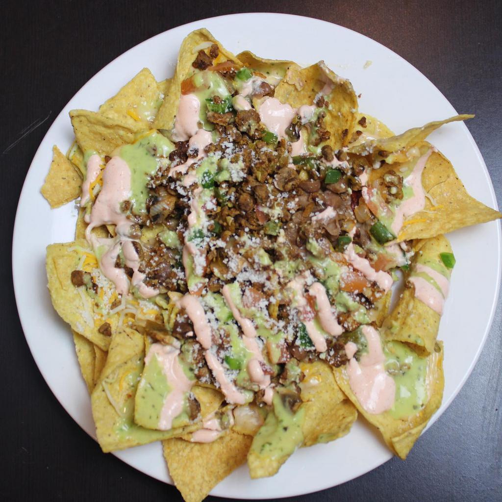 Chuco Nachos · Signature queso, frijoles, cotija, tomatoes, jalapenos, scenic sauce, avocado crema. Add chicken, steak, or shrimp for an additional charge. 