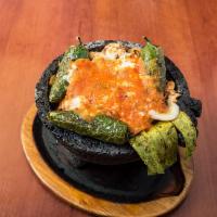 Molcajete · Your choice of grilled steak or chicken with sauteed onions, tomatoes and your choice of jal...