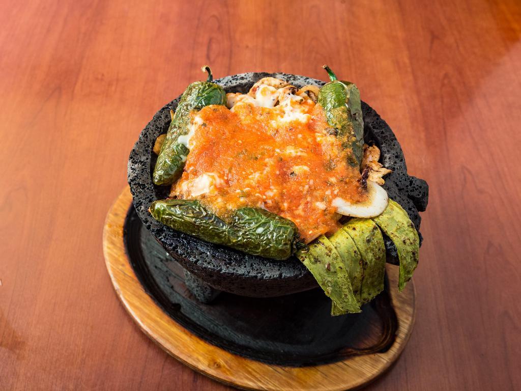 Molcajete · Your choice of grilled steak or chicken with sauteed onions, tomatoes and your choice of jalapeno, poblano or bell pepper. Topped with ranchero or tomatillo sauce and garnished with cambray onion, cactus leaf and a slice of white cheese. Served with tortillas, sour cream, pico de gallo, guacamole, rice and beans. Add shrimp for an additional charge.