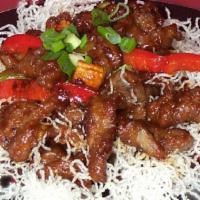 S6. Mongolian Beef · Sliced beef stir-fried with a savory brown sauce and chili peppers.  Paired with scallions a...