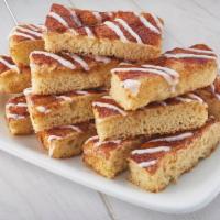12 Piece Cinnamon Stix · Freshly baked pizza dough with butter, cinnamon sugar and topped with vanilla icing.