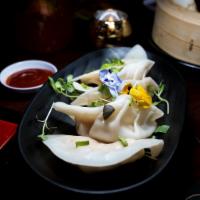 Thai Dumplings · Minced chicken finely chopped vegetables wrapped in a dough skin with chef's dipping sauce.