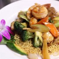 Pan-fried Noodle Hong Kong Style · Shrimp, beef and chicken sauteed with mixed vegetable in chef special sauce on top of pan-fr...