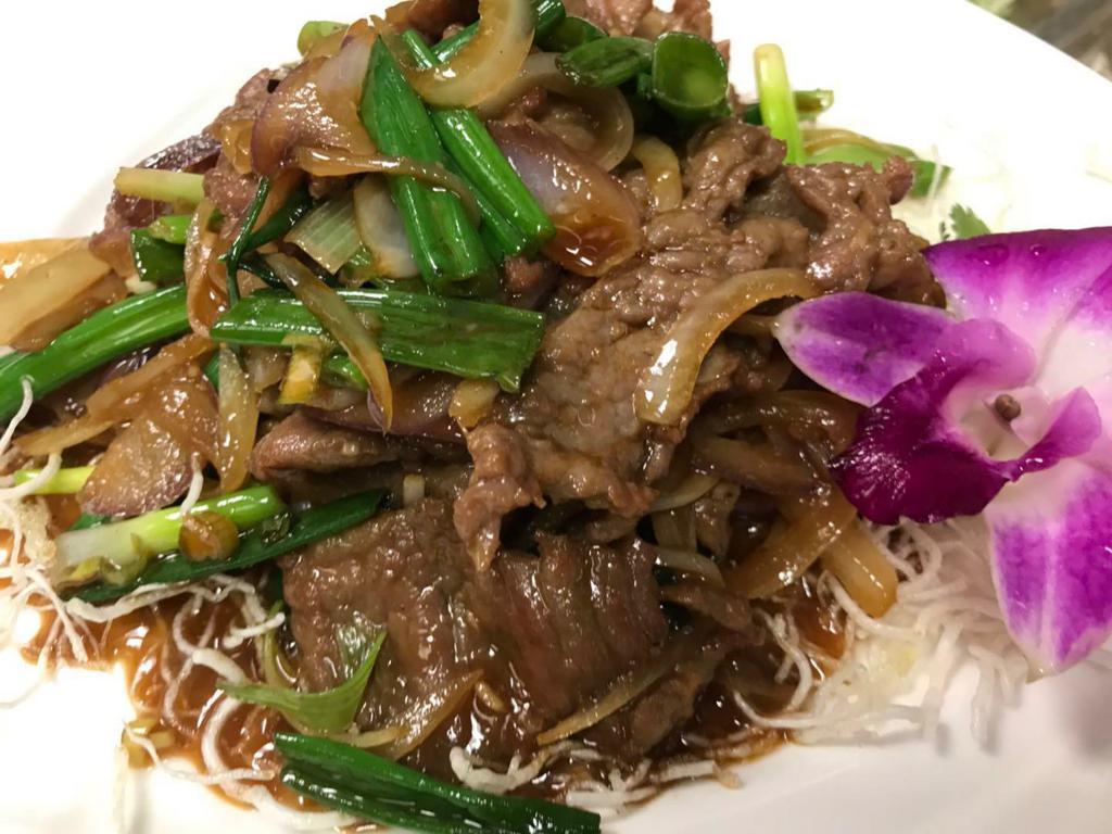 Mongolian Beef · Thinly sliced beef, scallions, garlic and ginger are stir-fried with a savory brown sauce and crispy noodle. 