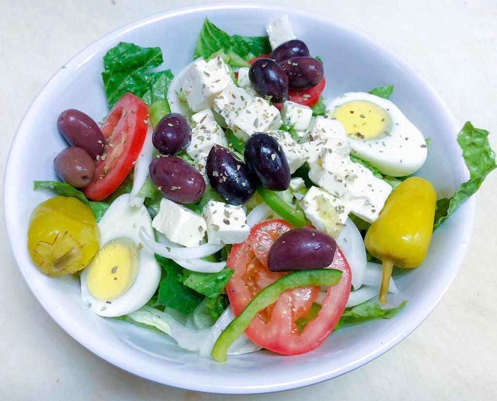Greek Salad · Crisp romaine and iceberg lettuce, tomato, cucumbers, green peppers, onions and egg topped with olives, feta and an pepperccini. Served with fresh warm garlic bread.