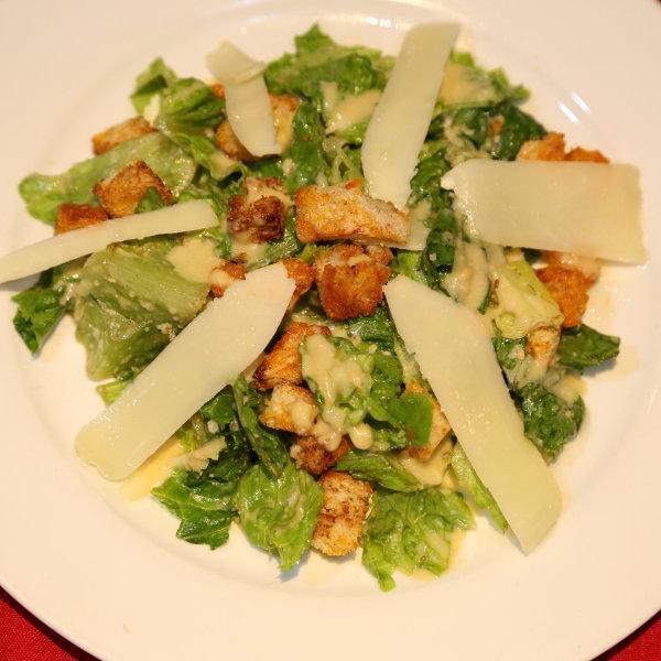 Insalata di Giulio Caesar · Classic style Caesar salad with shaved Pecorino Romano and croutons.