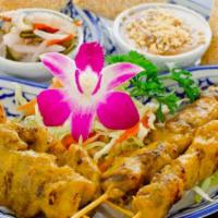 Chicken Satay · Chicken marinated in coconut milk, herbs and spices served with peanut sauce, toast and cucu...
