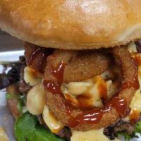 Backyard BBQ · Premium short rib burger topped with macaroni and cheese, tomato onion rings and BBQ sauce.