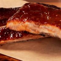 Ribs · St Louis style ribs rubbed with our special dry rub, smoked for four hours, then brushed wit...