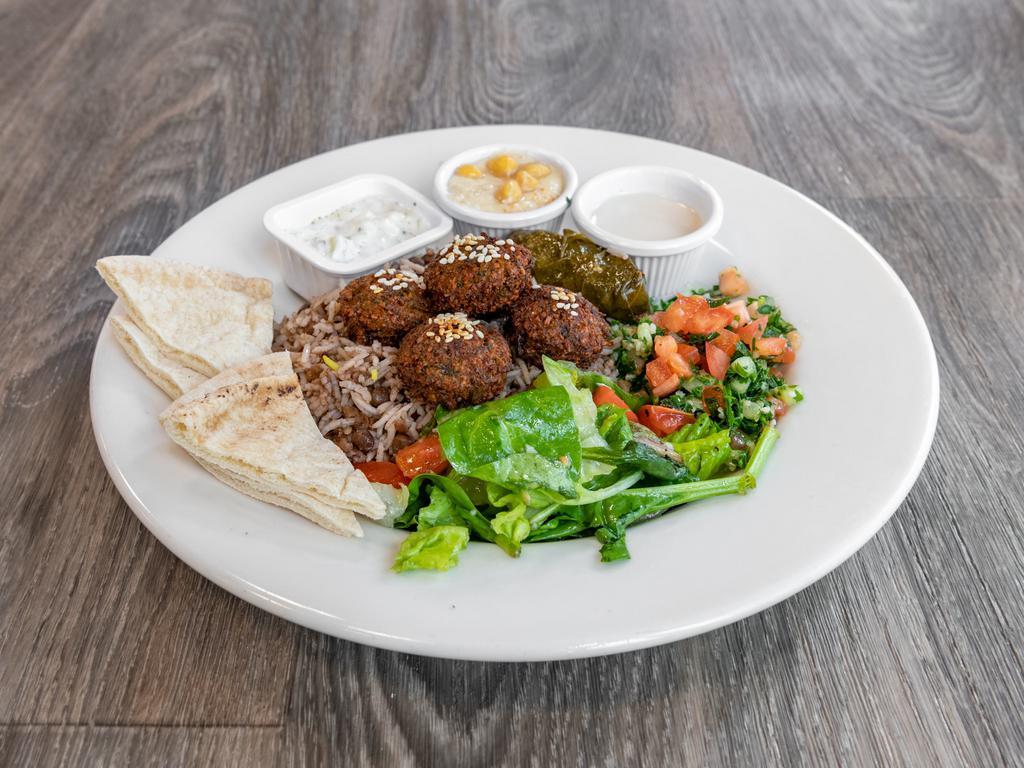 Greek  Lunch Platter · Falafel with lentil rice, hummus, tabbouleh, cucumber salad, Greek salad, dolma and pita bread.