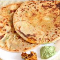 Aloo Paratha (2 pc) · Whole wheat bread stuffed potato mix and served with raita (yogurt) and or Indian pickle.