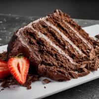 Bolo De Chocolate (Chocolate Cake) · Tiered chocolate cake with chocolate icing, topped with fresh strawberries, powdered with co...