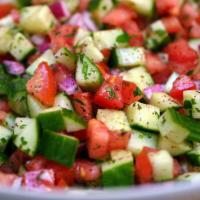 14. Shepherd Salad · Chopped fresh tomatoes, peppers, cucumbers, onions, parsley, olive oil and vinegar dressing.