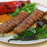 26. Lamb Adana Kebab · Char-grilled lamb seasoned with Turkish spices, tomato and pepper; served with rice and salad.