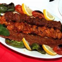 29. Mix Adana Kebab · Char-grilled chicken and lamb skewers seasoned with Turkish spices and served with rice and ...
