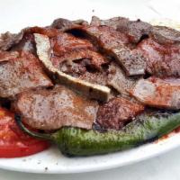 30. Iskender Kebab · Doner kebab served over sauteed homemade bread, topped with fresh tomato sauce and served wi...